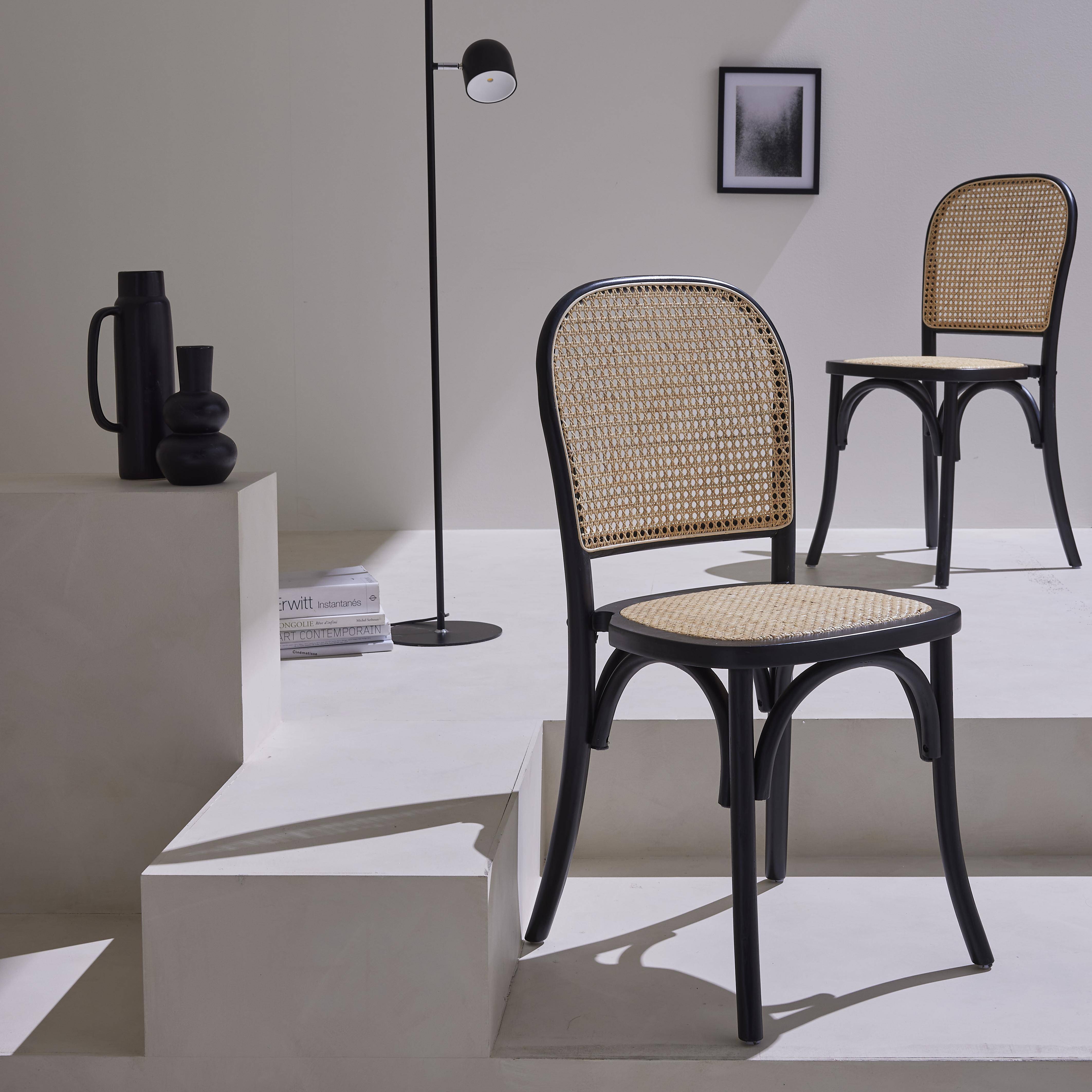 Set van twee vintage zwarte houten stoelen met rotan zitvlak en rugleuning Photo1