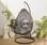 Uovo Hängesessel aus braunem Polyrattan mit grauem Kissen, eiförmig mit Retrolook| sweeek
